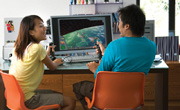 two young adults playing video game