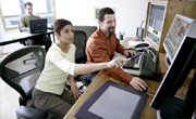 People working in a media editing station
