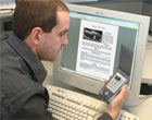 Researcher Anthony Wiley demonstrates multi-channel publishing on a PC and a PDA